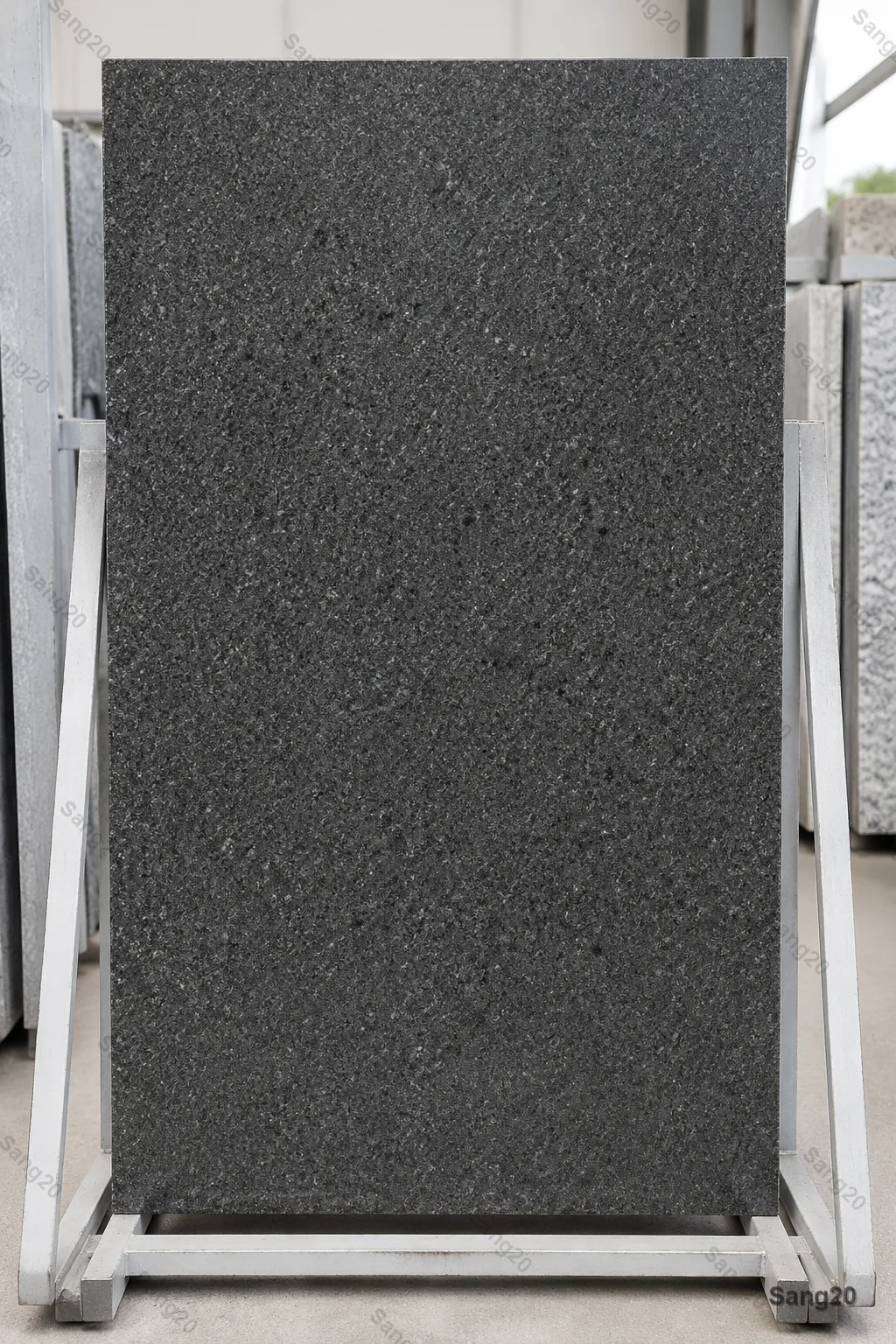 Polished Hamadan Granite slab, charcoal grey stone with fine salt-and-pepper texture, professional catalog product photography, high-resolution architectural material