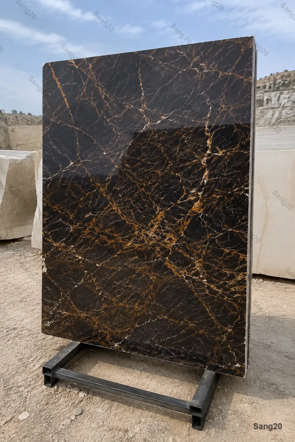 Golden Black marble slab, quarry sample 3, with amber-gold veins in an outdoor quarry yard