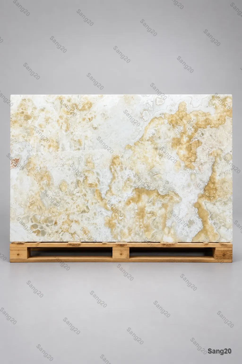 Premium polished white and cream onyx slab with soft golden cloud patterns on pallet showcase